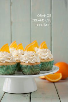 orange creamsicle cupcakes on a white cake plate