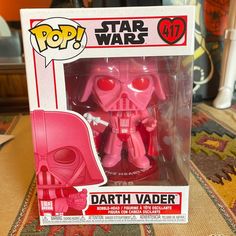 the pink darth vader pop vinyl figure is on display in its packaging box