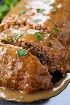 meatloaf with gravy on a plate and garnished with parsley