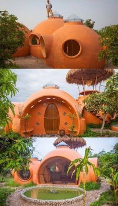 an unusual house made out of orange clay and surrounded by greenery, with a man standing on the roof