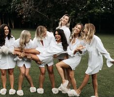 a group of women in white robes posing for a photo