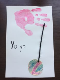 a piece of paper that says yo - yo with a hand print on it and a black string