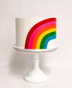 a white cake with a rainbow design on it