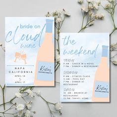 two bridal wine themed wedding cards on top of white flowers with blue sky in the background