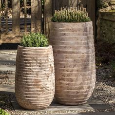 two large planters sitting next to each other