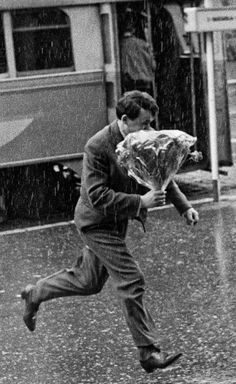 a man running in the rain with an umbrella