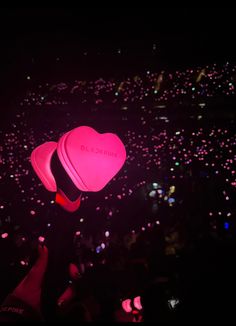 a pink heart shaped object floating in the air