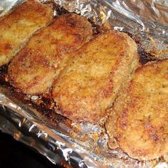 four fried meat patties sitting on top of tin foil