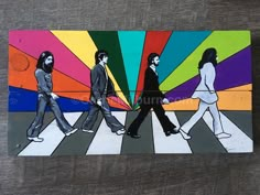 a painting of the beatles walking across a crosswalk with rainbows in the background