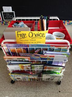 a stack of books sitting on top of a plastic bin next to a sign that says free choice