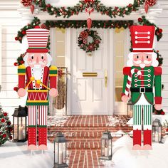 two christmas nutcrackers are standing in front of a house decorated for the holiday season