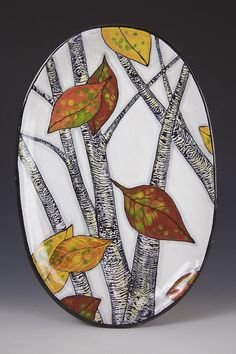 a decorative plate with leaves on it