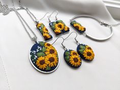 the sunflowers are painted on this necklace and earring set