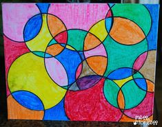 an art project with colored circles on paper