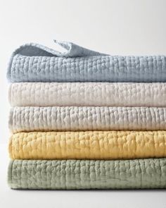 a stack of folded towels sitting on top of each other