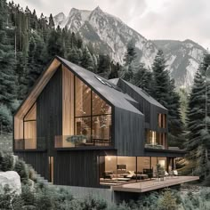 a house in the middle of some trees and mountains