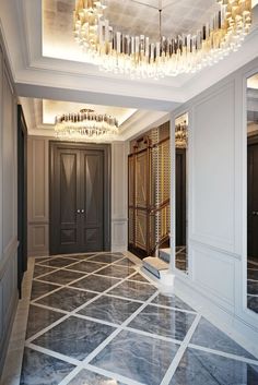 an empty hallway with chandelier and marble flooring