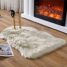 a living room with a fire place and a rug on the floor next to it