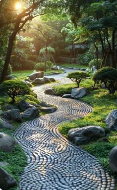 a stone path in the middle of a garden with rocks and grass on either side