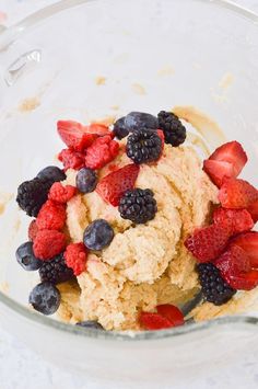 a bowl filled with ice cream and berries