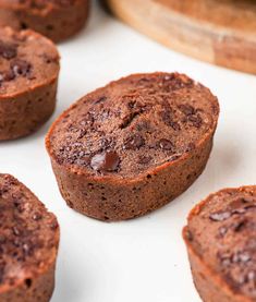 several chocolate muffins sitting on top of a white surface