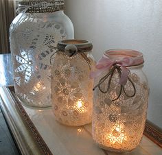 two mason jars with lace doily on them