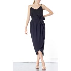 The Blake Tulip skirt is super flattering on any size. Coming in one size fits all, this wrap-around tulip style is designed to sit high on the waist. It's finished with a wrap-around belt that ties at the side, to nip in your waist for a flattering effect. Tie into a bow or leave as it is. This dramatic outline is best complemented with a fitted top. Hand wash recommended Wash with like colours to avoid colour transfer Press on reverse side Iron on low heat  100% polyester Chic Black Draped Maxi Skirt, Elegant Fitted Wrap Skirt, Chic Asymmetrical Draped Skirt, Chic Asymmetrical Hem Wrap Skirt For Evening, Chic Draped Maxi Skirt, Chic Asymmetrical Draped Skirt For Night Out, Chic Asymmetrical Wrap Skirt For Evening, Chic Evening Wrap Skirt With Asymmetrical Hem, Chic Draped Lined Skirt