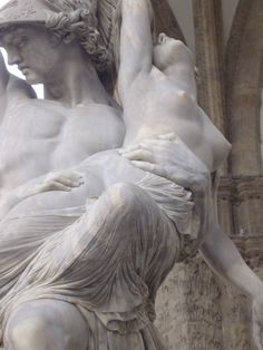 an image of a statue that looks like it is holding the back of a woman