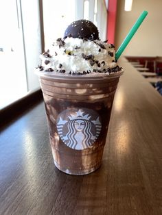 a starbucks drink with whipped cream, chocolate and sprinkles