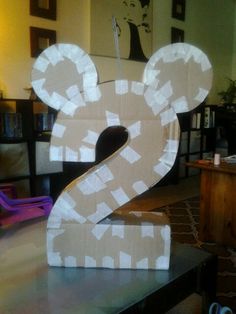 a cardboard mickey mouse number 2 sitting on top of a table