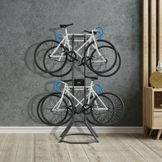 there is a bike rack in the room with three bikes hanging from it's sides