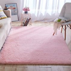 a living room with a pink rug on the floor