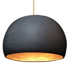 a black and gold pendant light hanging from a ceiling