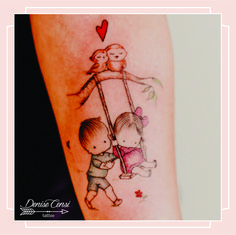 a small tattoo on the arm of a boy and girl swinging on a swing with a heart above them