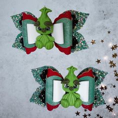 Christmas Grinch Faux Leather Hair Bow, Christmas Grinch Hair Clip, Holiday Hair Bow, 5 Layer Hair Bow, Hair Accessories, Hair Fashion, Girl Hair Bow, Pig Tail Hair Bows A very cute and festive handmade Christmas hair bow perfect for the upcoming holiday.  In this listing, you get 2 Christmas hair bows that are each 4" wide along with a cute clay Grinch doll attached to the bows.  The leather is both glitter and smooth texture in Christmas style *BOW MEASUREMENTS: approximately 4" W X 2" L *CLAY DOLL: approximately 2.5" H X 1.5" W *MATERIALS: Made from vegan leather vinyl. Clay doll made from polymer clay.  *HARDWARE: The hair clip is a metal alligator style clip. It is approximately 2.25" wide.  The metal clip is already attached to the bow. All bows in my shop are cut with my Sizzix mach Clay Grinch, Grinch Hair, Grinch Fingers, Bow Measurements, Layer Hair, Holiday Hair Bows, Tail Hair, Clay Doll, Holiday Hair