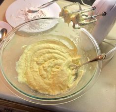 a bowl filled with batter next to a mixer