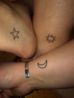 two people with matching tattoos on their feet, one has a sun and the other has a crescent