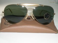 You are bidding on brand new (New Old Stock MADE IN USA), stunning looking 62[]14mm large size 1960's pre-BL etching era VINTAGE B&L RAY BAN G15 GOLD ELECTROPLATED OUTDOORSMAN II AVIATOR SUNGLASSES. Top of cross bar reads B&L RAY-BAN USA & underneath reads B&L RAY-BAN 62[]14. Measures 5 5/8" across the hinges, overall vertical height is slightly over 2" and length of temple is 5". Consolidated shipping is offered on multiple items purchased. Thanks for bidding!!! Vintage Aviator Sunglasses With Gradient Lenses For Formal Occasions, Vintage Aviator Sunglasses With Gradient Lenses For Formal Events, Vintage Aviator Sunglasses With Mirrored Lenses, Vintage Aviator Sunglasses With Tinted Lenses, Vintage Aviator Sunglasses, Cross Bar, Real Man, 1960s Vintage, New New