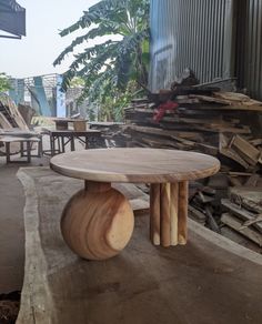 a wooden table sitting on top of a pile of wood