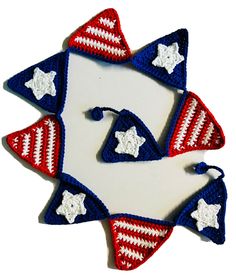 three crocheted stars and stripes are arranged in the shape of an ornament