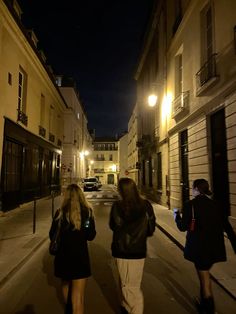 two women walking down the street at night