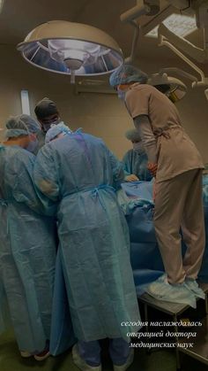 several doctors in scrubs are performing surgery