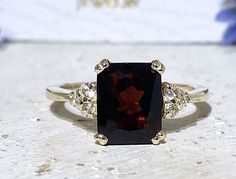 Don't miss this opportunity to own this beautiful gemstone ring! => Gemstone Type - Garnet, Clear Quartz => Gemstone Cut - Faceted => Gemstone Size - 8*10 mm, 2 mm => Total Number of Gemstones - 7 => Metal Type - 14k Gold Filled (Tarnish Resistant and Nickel Free) - also available in 925 sterling silver and 14k solid gold * Please contact me for pricing on sizes larger than 11 * ~ Feel free to ask me about custom made designs. ❏ Replacements and custom orders: ✪ 925 sterling silver - no addition Rectangle Engagement Ring, Ring Rectangle, Vision 2024, Gold Ring Engagement, Rectangle Ring, Black Onyx Engagement Ring, Onyx Engagement Ring, Garnet Engagement Ring, Red Garnet Ring