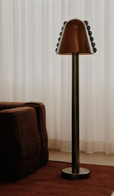 a lamp that is sitting on top of a table next to a couch and chair