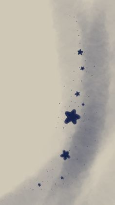 some blue stars are flying in the sky with clouds behind them and one is upside down