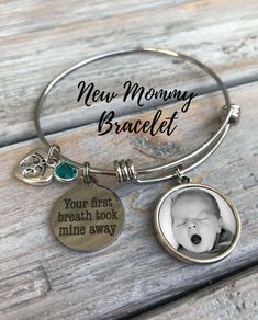 a bracelet with a baby's photo and the words new mommy, bradley on it