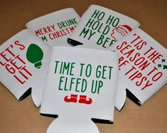 four white coasters with red and green designs on them, one says it's christmas time to get left up