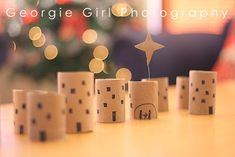 some dices are sitting on a table near a christmas tree with lights in the background