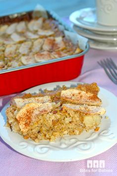 a white plate topped with food next to a casserole dish