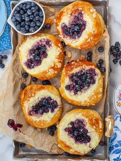 blueberry danish pastries are on a tray